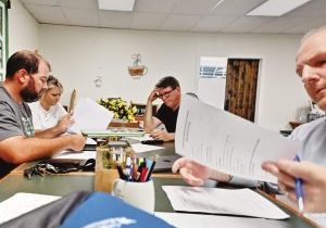Looking over the minutes before approval. From the left are the board members of the Burkesville – Cumberland County Industrial Development Authority: Treasurer Brian Scott, Michelle Bell, Jim Neathery, Glen Murphy, and the president, Dr. Elijah Wilson. The remaining board member, Greg Wells, is out of the frame. PHOTO | Greg Wells
